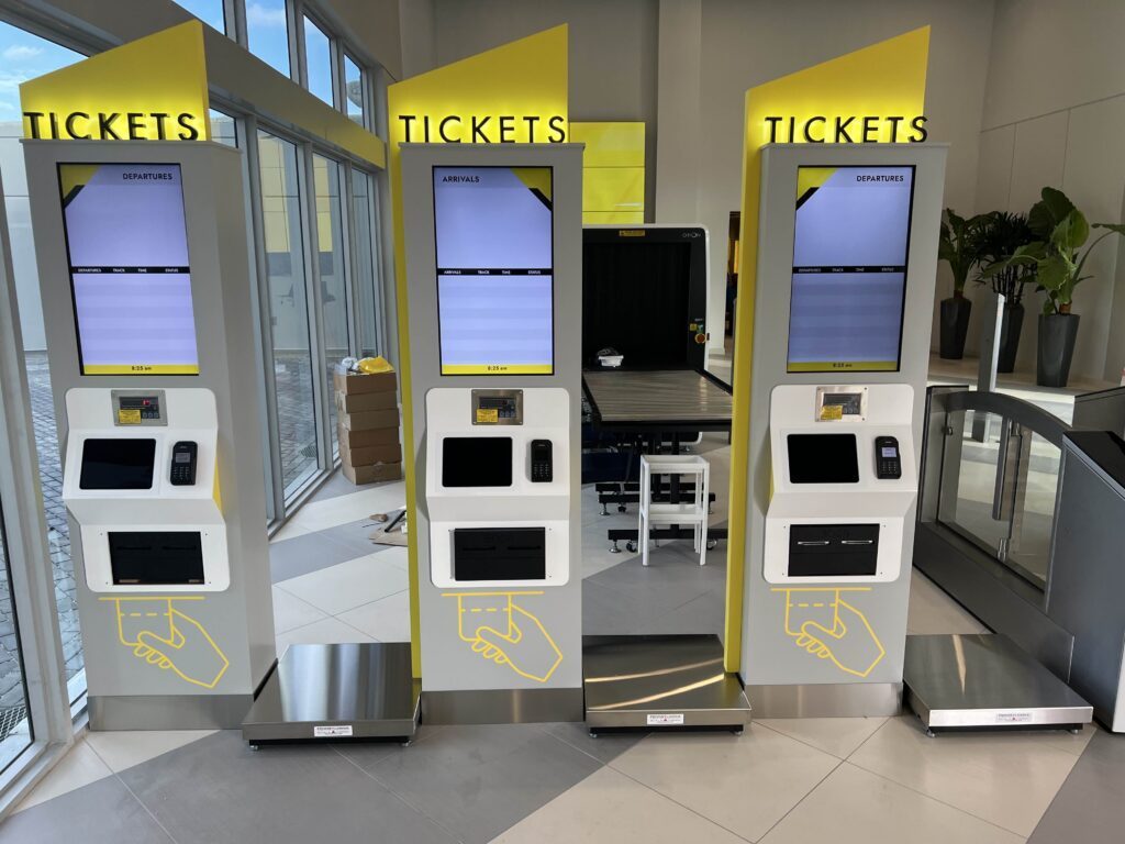 Ticket kiosks with departures and arrivals displays
