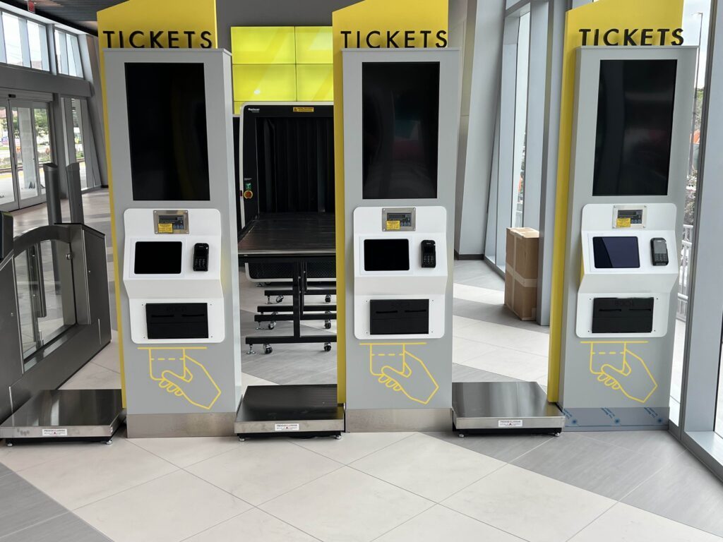Self-service ticket kiosks with integrated weighing platforms